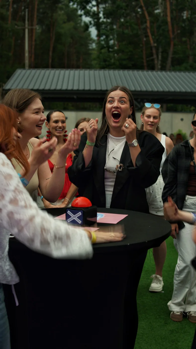 A G.Bar guest reacts with emotion during a team contest with a buzzer