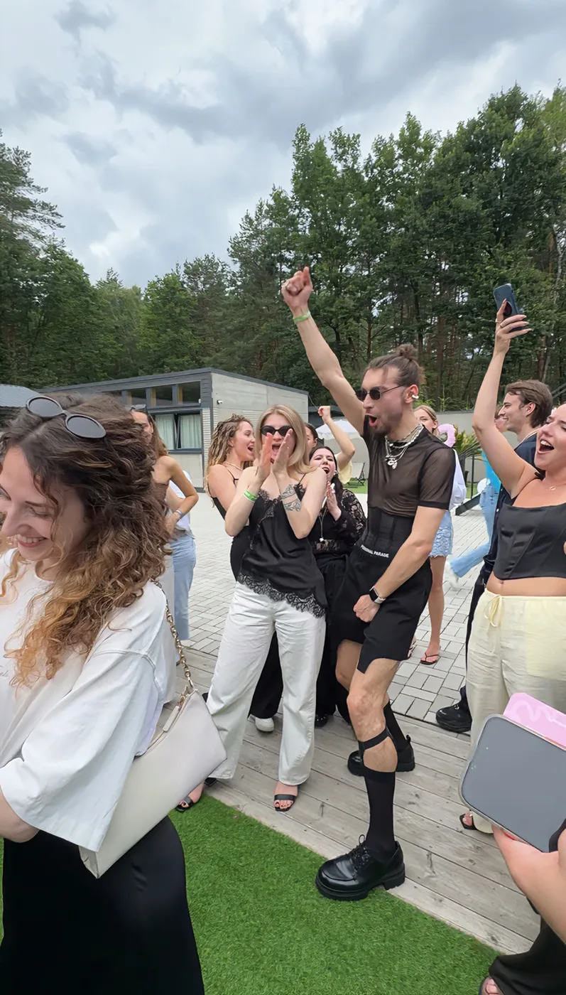 Guests dance on the villa terrace amid the forest