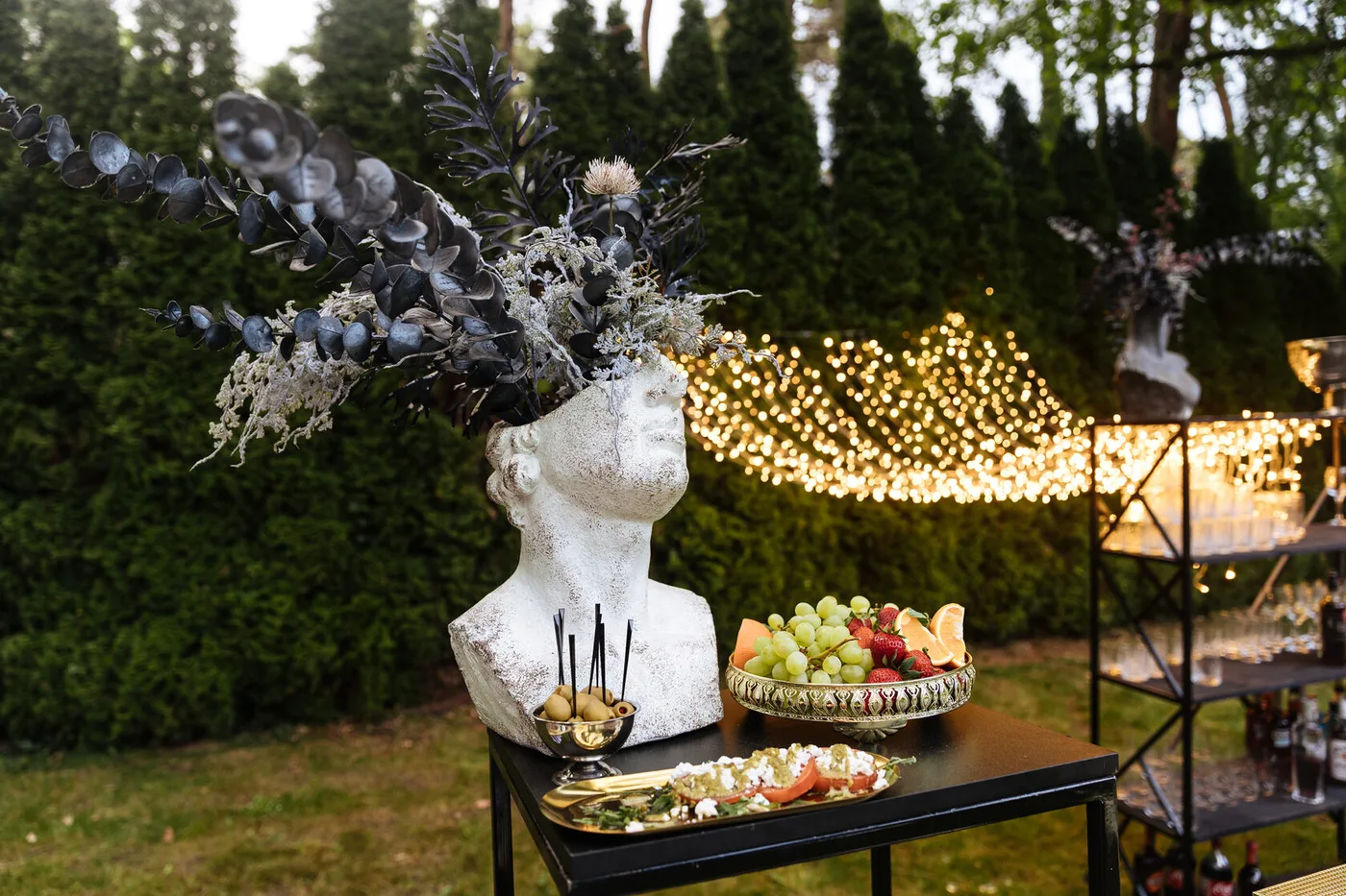 Italian appetisers, olives and fruit on a decorated celebration table