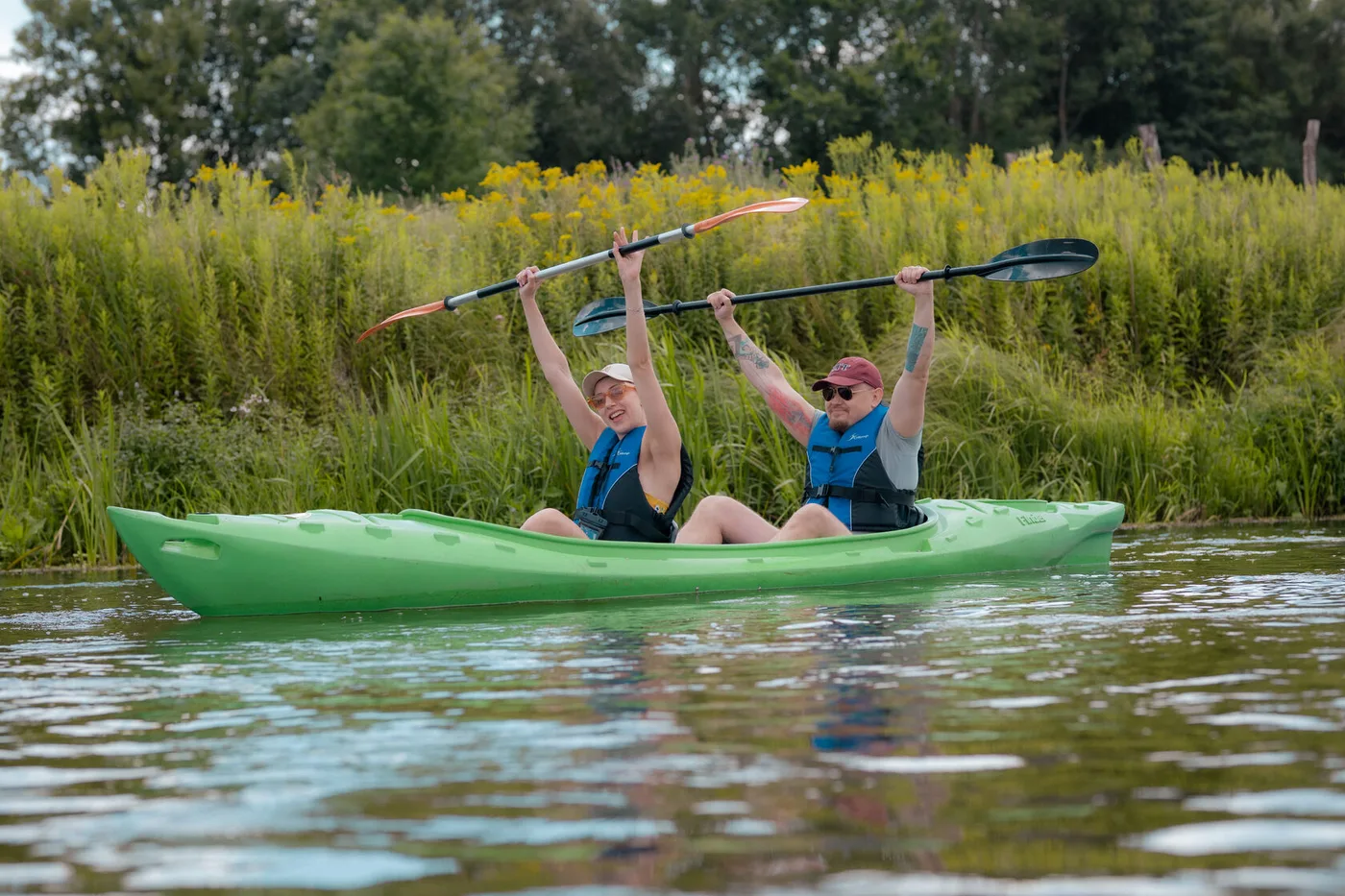Participants paddling a two-seater kayak along the river route