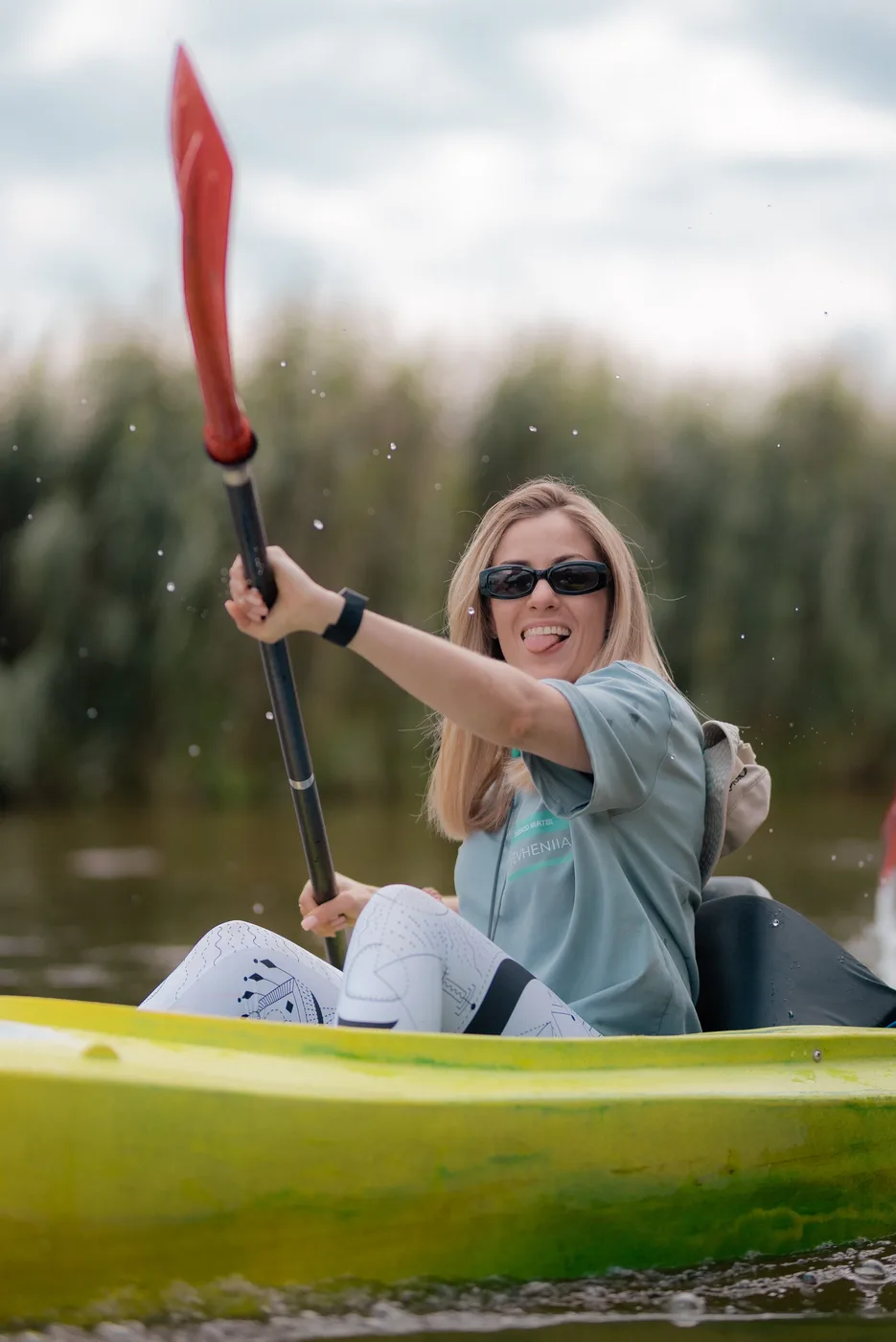 A participant paddling a kayak along the river during the trip