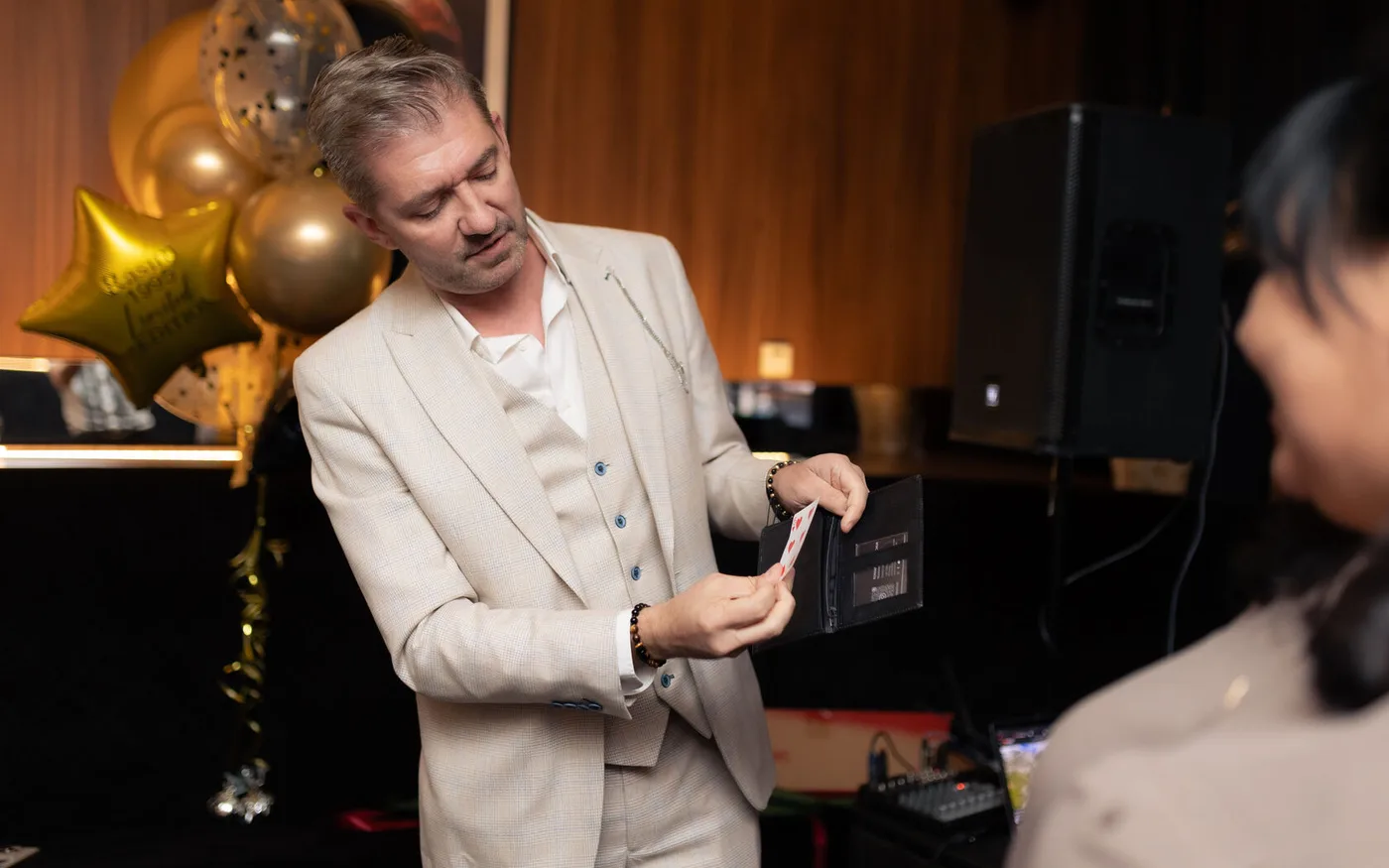 The illusionist performing a playing-card routine for guests of the evening