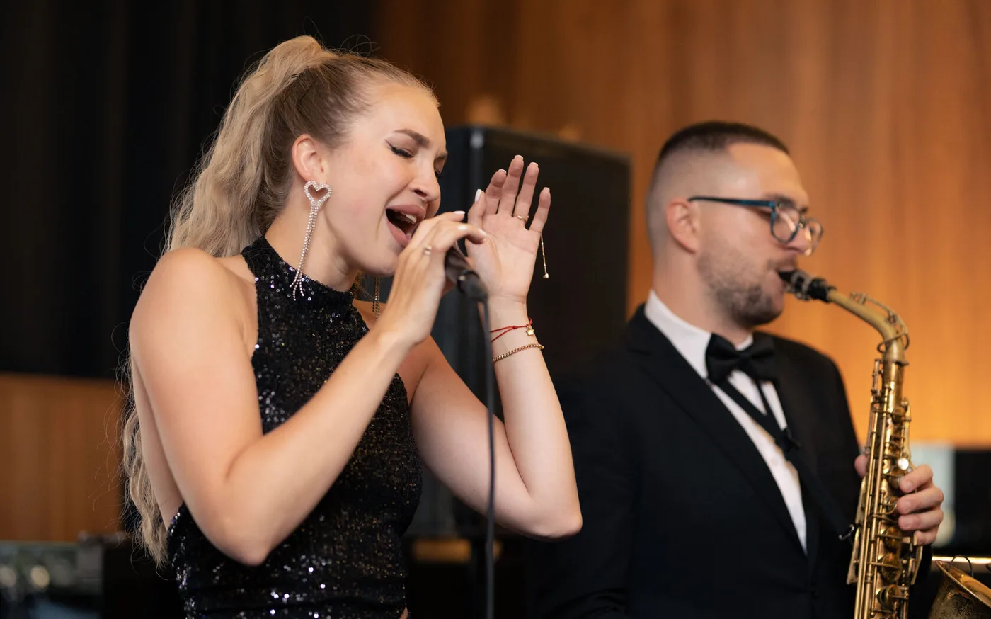 The cover band's vocalist and the saxophonist during a live set at STIXX