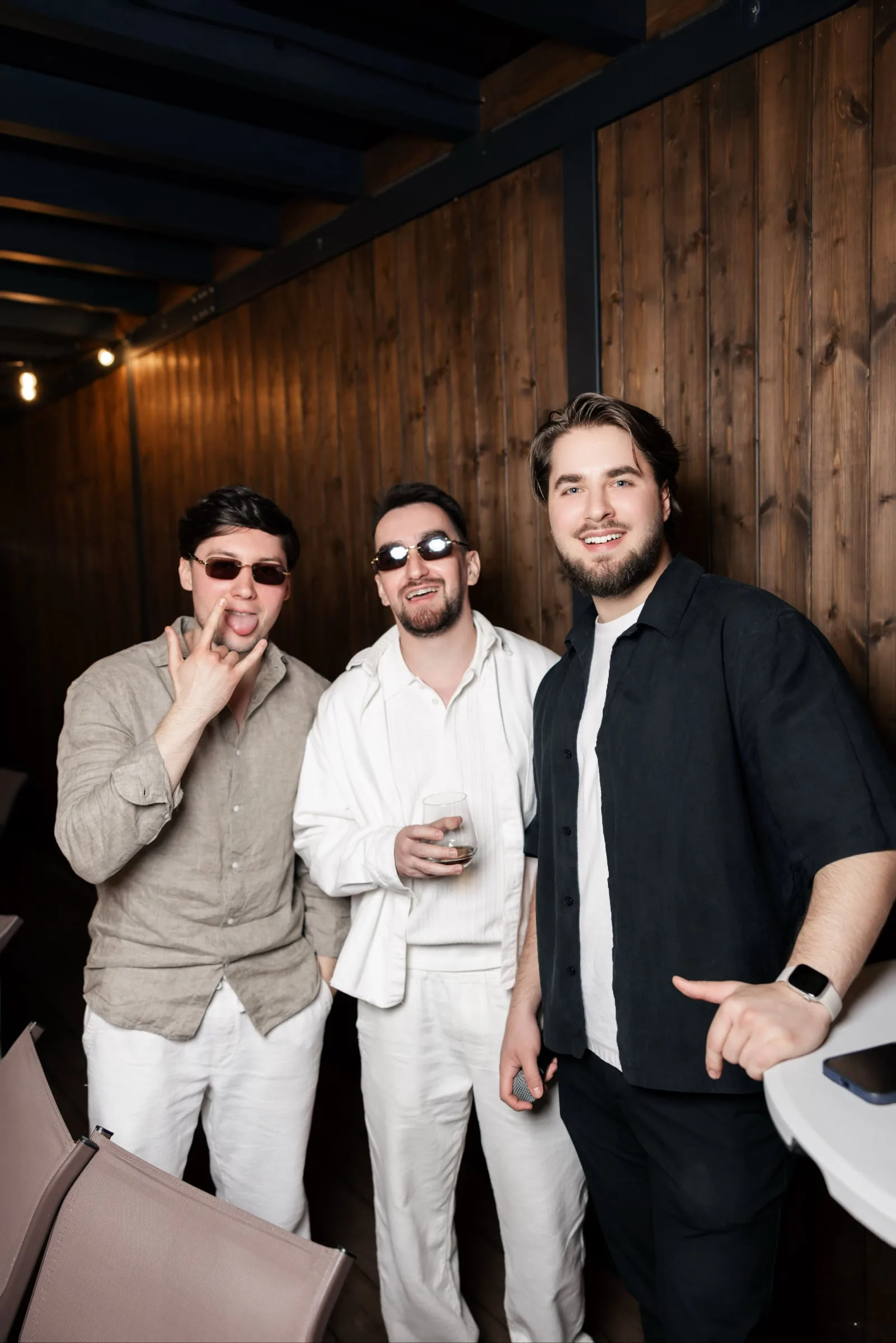 Makar posing with two guests in sunglasses for a playful photo
